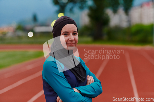 Image of A Muslim woman with a burqa, an Islamic sportswoman resting after a vigorous training session on the marathon course. A hijab woman is preparing for a marathon competition