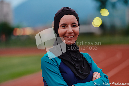 Image of A Muslim woman with a burqa, an Islamic sportswoman resting after a vigorous training session on the marathon course. A hijab woman is preparing for a marathon competition