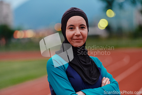 Image of A Muslim woman with a burqa, an Islamic sportswoman resting after a vigorous training session on the marathon course. A hijab woman is preparing for a marathon competition