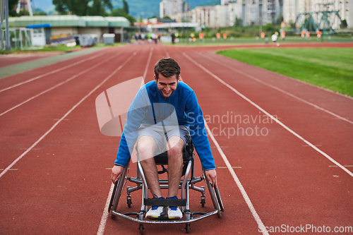 Image of A person with disability in a wheelchair training tirelessly on the track in preparation for the Paralympic Games