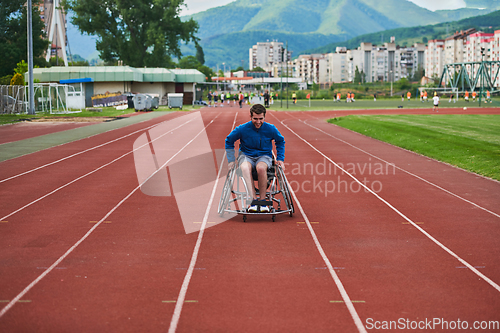 Image of A person with disability in a wheelchair training tirelessly on the track in preparation for the Paralympic Games