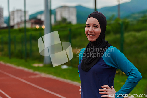 Image of A Muslim woman with a burqa, an Islamic sportswoman resting after a vigorous training session on the marathon course. A hijab woman is preparing for a marathon competition