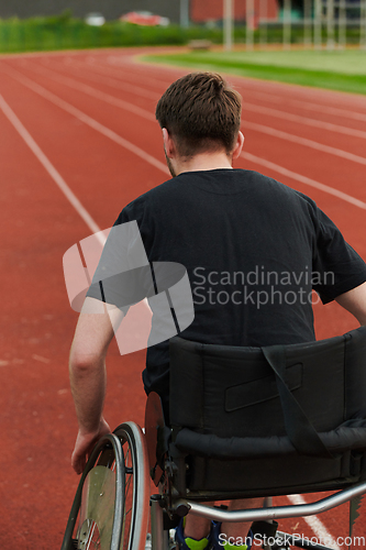 Image of A person with disability in a wheelchair training tirelessly on the track in preparation for the Paralympic Games