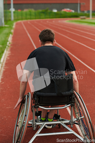 Image of A person with disability in a wheelchair training tirelessly on the track in preparation for the Paralympic Games