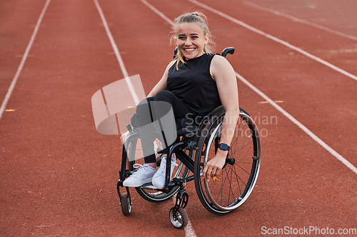 Image of A woman with disablity driving a wheelchair on a track while preparing for the Paralympic Games