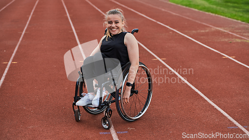 Image of A woman with disablity driving a wheelchair on a track while preparing for the Paralympic Games