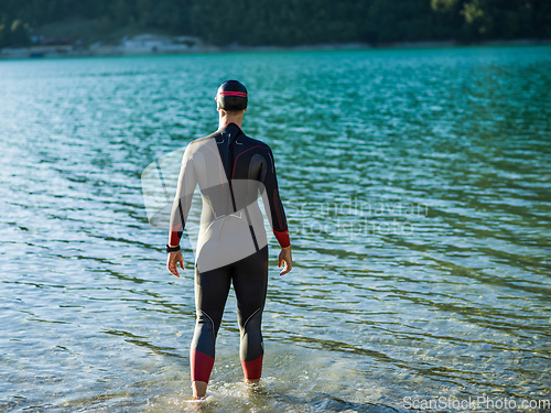 Image of A triathlon swimmer preparing for a river training to gear up for a marathon