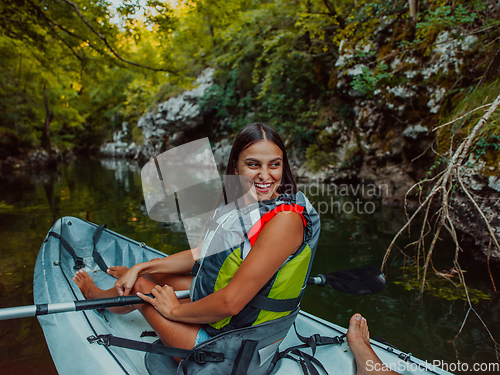 Image of A smiling woman enjoying a relaxing kayak ride with a friend while exploring river canyons