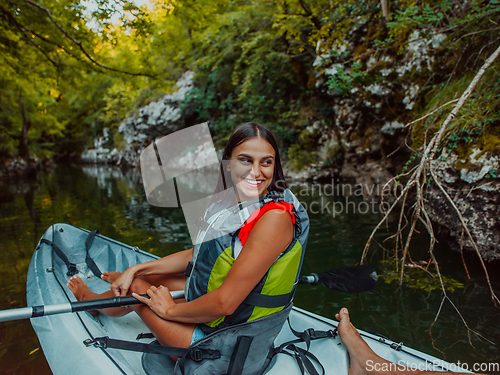 Image of A smiling woman enjoying a relaxing kayak ride with a friend while exploring river canyons