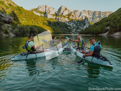 Image of A group of friends enjoying having fun and kayaking while exploring the calm river, surrounding forest and large natural river canyons