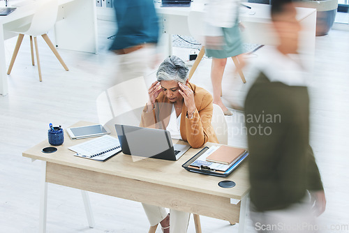 Image of Busy office, stress and senior woman with headache, crisis or vertigo while working on a laptop. Corporate, chaos and lady ceo with temple massage for migraine, brain fog or 404, glitch or anxiety