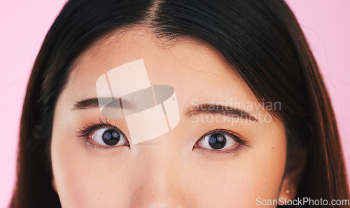 Image of Closeup, eyes and portrait of an Asian woman on a pink background for makeup or microblading. Face, skincare and a girl or model isolated on a backdrop for facial cosmetics, foundation or eyeliner