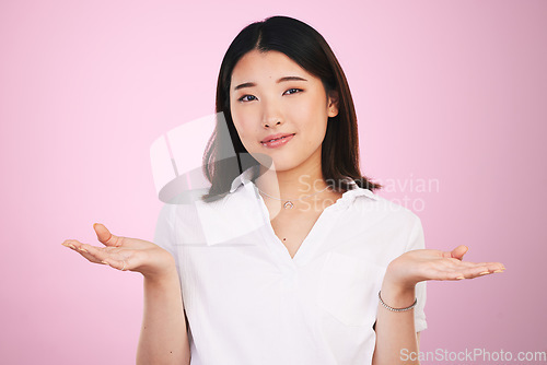 Image of Doubt, decision and portrait of Asian woman on pink background for unsure, uncertainty and question. Thinking, confused and face of person with hand gesture for option, choice and emoji in studio