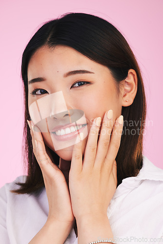 Image of Face, skincare and woman with manicure hands in studio isolated on a pink background. Portrait, beauty cosmetics and touch of happy Asian model in facial treatment for health, wellness or aesthetic