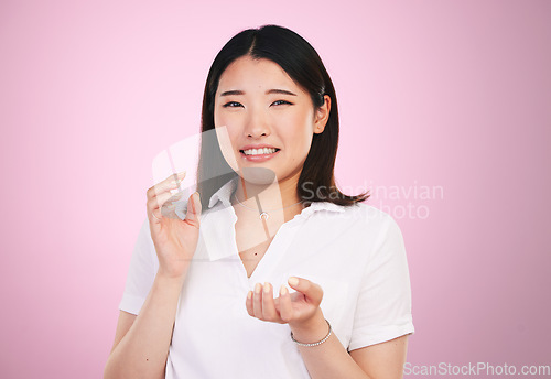 Image of Portrait, confused and question with an asian woman on a pink background in studio for problem solving. Face, doubt and why with a young female person thinking about a mistake, error or fail