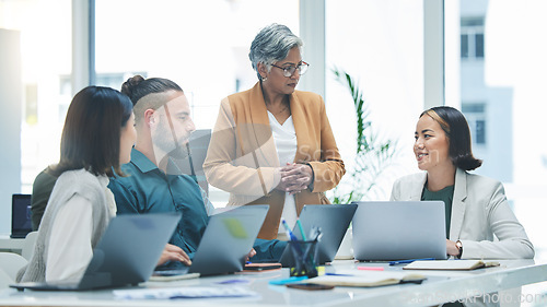 Image of Business people, laptop and meeting, productivity and marketing strategy, creative group at digital agency and team. Man, women and diversity, working together and senior leader with branding ideas