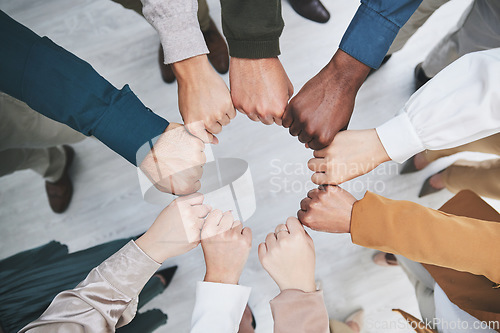 Image of Hands, fist bump and team, support with solidarity and business people with top view and community. Synergy, cooperation and huddle, collaboration and corporate group with trust, meeting and mission