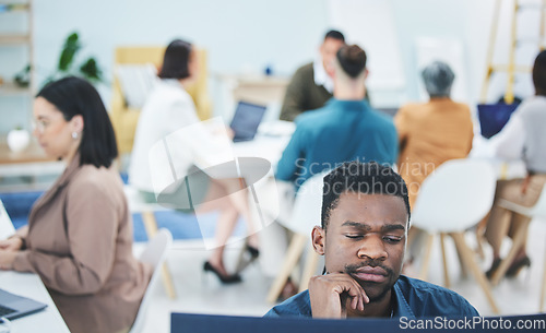 Image of Man, reading and thinking on computer in office with employees, staff and workplace with business people working. Confused, businessman and report on company productivity or learning tech information