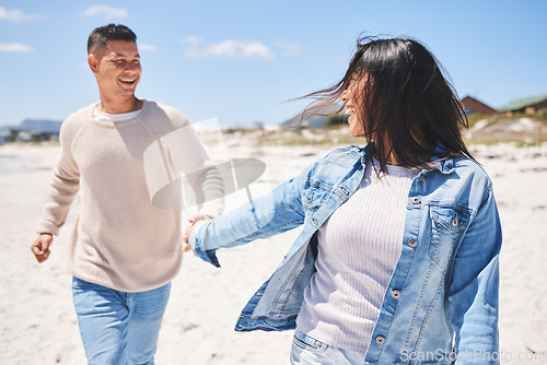 Image of Love, smile and holding hands with couple at beach for travel, summer vacation and romance together. Happy, relax and bonding with man and woman walking on seaside holiday for care, date or honeymoon