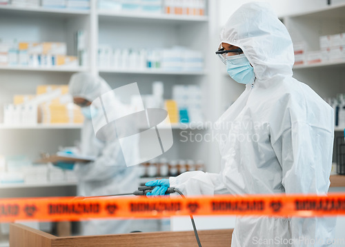 Image of Biohazard, chemical and disinfect with people in a pharmacy for decontamination after a medical accident. Hazmat, spray or cleaning with healthcare personnel in a drugstore to sanitize and isolate