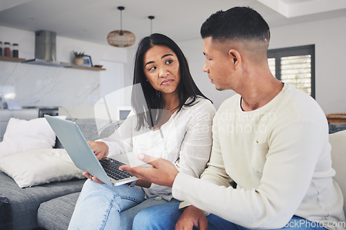 Image of Couple, laptop and decision, doubt on sofa for online shopping or business idea in living room or home. Computer, man and woman with choice on internet for financial planning with tech subscription