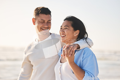 Image of Love, smile and hug with couple at beach for travel, summer vacation and romance together. Happy, relax and bonding with man and woman walking on seaside holiday for care, date and honeymoon