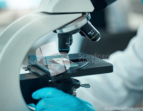 Image of Microscope, medical science and blood sample in a laboratory for analysis, study or development. Zoom on equipment for research, future and gloves of scientist with virus, particle or dna test