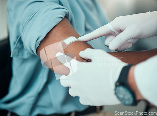 Image of Plaster on arm, vaccine and wound, hands of doctor with patient and health, medicine and medical procedure. Bandage, injury and injection with people at hospital, healthcare and wellness with help