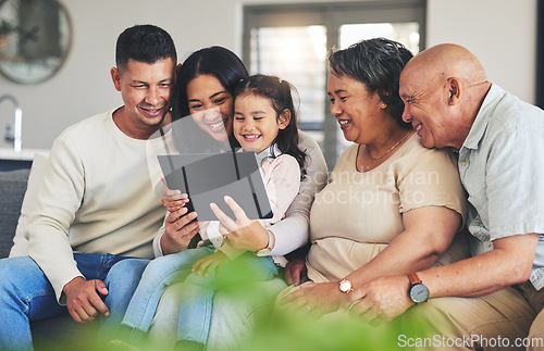 Image of Tablet, family and children on a sofa in the living room together during a visit with grandparents in retirement. Parents, senior people and kids using technology while browsing social media or games