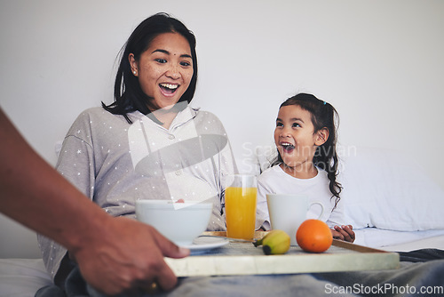 Image of Surprise, breakfast and mother with child in bed relaxing on weekend morning at their home. Happy, smile and young mom enjoying healthy food for brunch meal with her daughter for mothers day in house