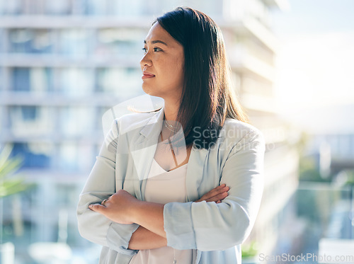 Image of Thinking, crossed arms and businesswoman in the office with confidence and brainstorming ideas. Young, career and professional Asian female lawyer standing and planning with pride in modern workplace