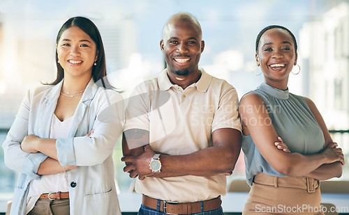 Image of Happy, crossed arms and portrait of a business people in the office with confidence and happiness. Young, corporate and face headshot of group of professional designers standing in a modern workplace