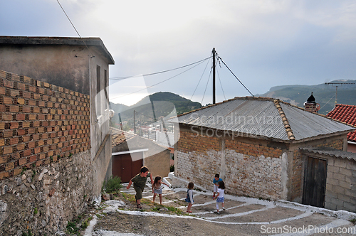 Image of children playing narrow alley