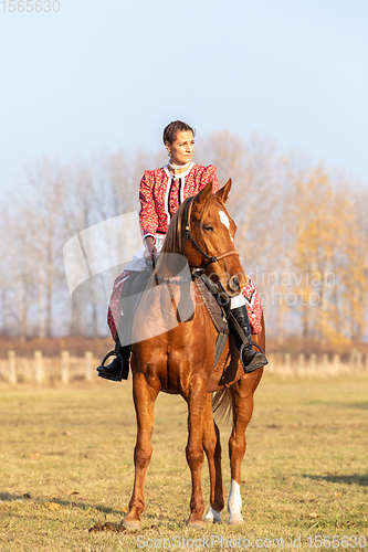 Image of Hungarian csikos horsewoman in traditional folk costume