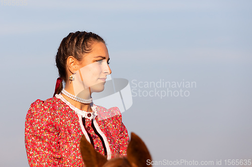 Image of Hungarian csikos horsewoman in traditional folk costume