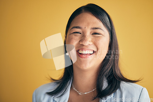 Image of Face, happy and Asian woman, designer and entrepreneur in studio isolated on a yellow background mockup space. Portrait, funny and creative professional, worker laugh and startup employee in Cambodia