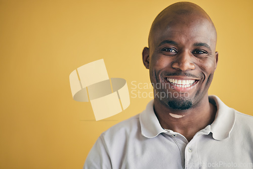 Image of Face, smile and black man, designer and entrepreneur in studio isolated on a yellow background mockup space. Portrait, happy and creative African professional, worker and employee in startup company