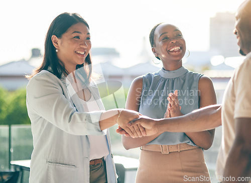 Image of Business people, handshake and applause in collaboration, deal or agreement in city. Shaking hands, happy and group clapping in b2b partnership, celebration and congratulations in startup acquisition