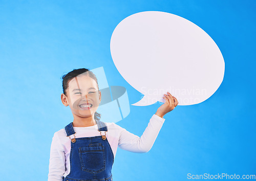 Image of Girl child, speech bubble and studio portrait for smile, mockup space and excited by blue background. Female kid, paper billboard and happy for news, info and promo of deal, discount and social media