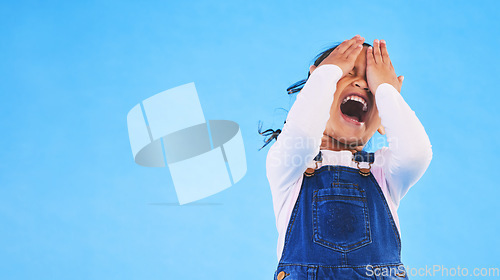 Image of Scared, horror and kid screaming, cover face and studio isolated on a blue background mockup space. Fear, terror and scary girl child in nightmare, anxiety crisis and shouting for problem in danger