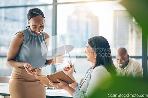 Image of Teamwork, diversity and notebook with business woman planning their schedule or calendar in the office. Collaboration, agenda and a professional employee reading a journal or diary with her colleague