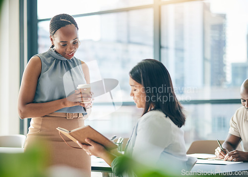 Image of Collaboration, agenda and notebook with business woman planning their schedule or calendar in the office. Teamwork, diversity and a professional employee reading a journal or diary with her colleague