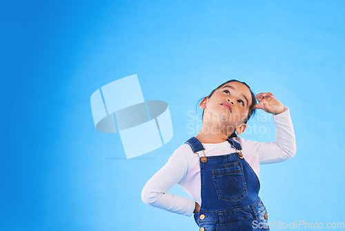 Image of Children, thinking and a girl on a blue background mockup in studio for marketing or advertising. Banner, space and idea with a cute young child posing for a decision on kids fashion or style