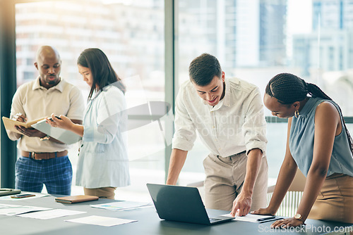 Image of Meeting, business people with laptop and paperwork for workshop, motivation and collaboration. Teamwork, men and women at office desk together with computer, documents and brainstorming in training.