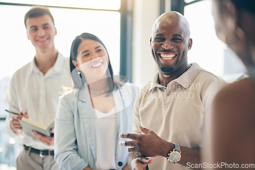 Image of Happy, planning and diversity with business people in a meeting for a discussion while laughing. Corporate, office and employees together, speaking and a funny conversation at work with a smile