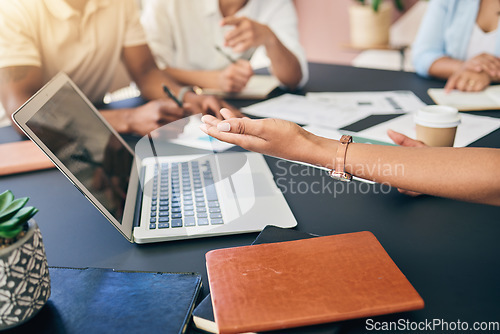Image of Meeting, hands of business people with laptop and paperwork for training, motivation and collaboration. Teamwork, men and women at office desk with computer, documents and brainstorming at workshop.
