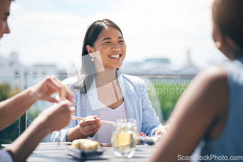 Image of Conversation, happy and friends eating lunch on a rooftop of a building on break together at the office. Smile, discussion and business people talking, bonding and enjoying a meal on the balcony.