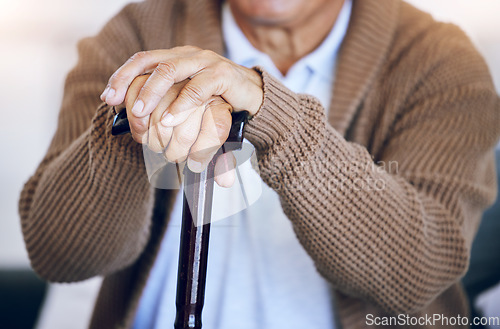 Image of Hands, walking stick and senior person with a disability in nursing home for mobility support, help and balance closeup. Elderly patient, fingers and cane in house living room or arthritis healthcare