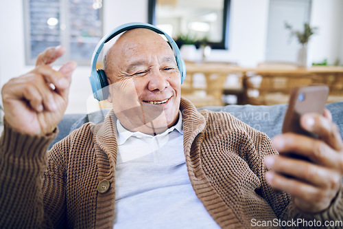 Image of Phone, senior man and watch music video, streaming podcast and reading happy story, news article or retirement blog. Home, smartphone and elderly person with headphones, relax and listening to song