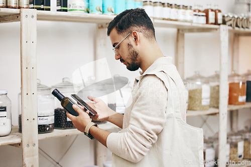 Image of Man, shopping and phone for reading grocery product, healthy food and organic oil information in store. Research, thinking and nutritionist customer with technology for supermarket choice or decision